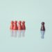 help your child against peer pressure, 5 red game pieces with a black one stood apart