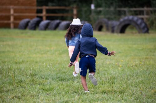 Children running in field. Image for how to survive summer holidays